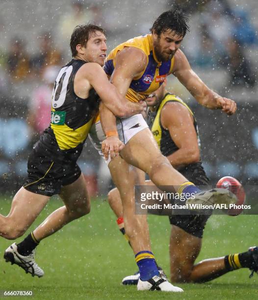 Josh Kennedy of the Eagles is tackled by Reece Conca of the Tigers during the 2017 AFL round 03 match between the Richmond Tigers and the West Coast...