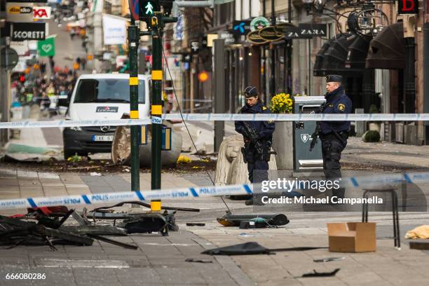 Police attend the scene of the terrorist attack where a truck crashed after driving down a pedestrian street in downtown Stockholm on April 8, 2017...