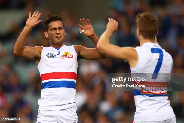 Luke Dahlhaus and Lachie Hunter of the Bulldogs celebrate a goal during the round three AFL match between the Fremantle Dockers and the Western...