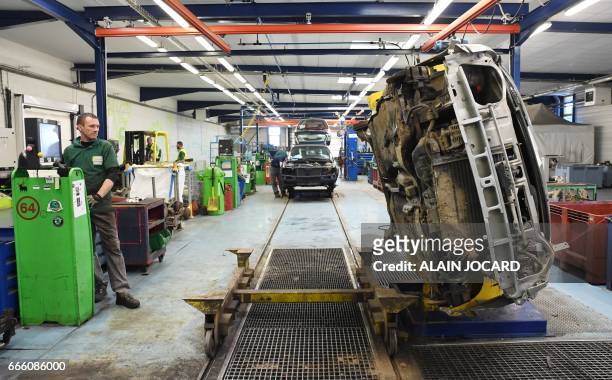 Worker dismantles parts of a car before recycling, at the Indra Automobile Recycling centre in Pruniers-en-Sologne near Blois, central France, on...