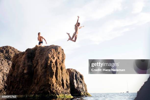 kids diving off the cliff - cliff dive stock pictures, royalty-free photos & images