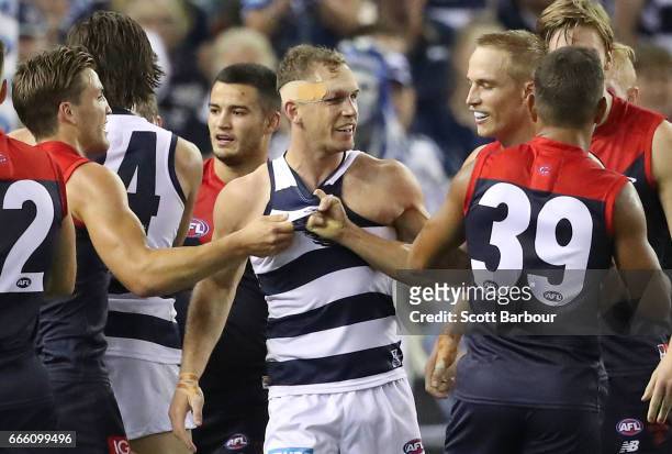 Joel Selwood of the Cats wrestles with Bernie Vince of the Demons and Jack Viney of the Demons during the round three AFL match between the Geelong...