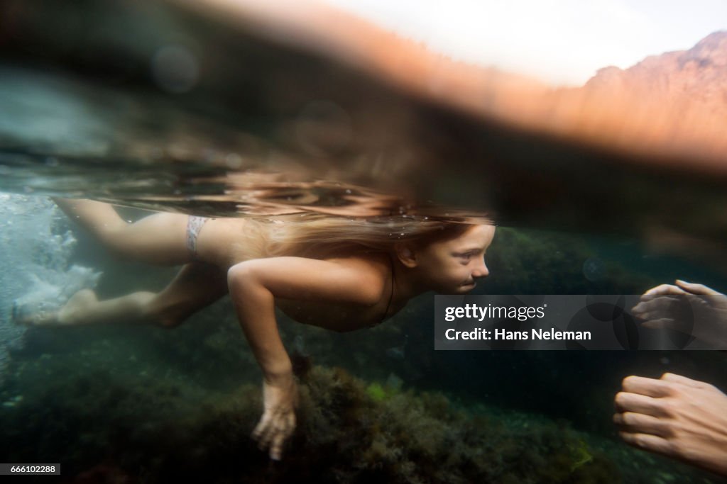 Underwater view of a girl diving