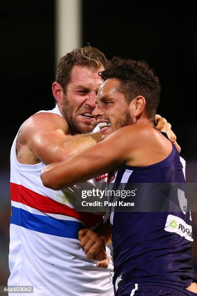 Michael Johnson of the Dockers and Travis Cloke of the Bulldogs wrestle during the round three AFL match between the Fremantle Dockers and the...