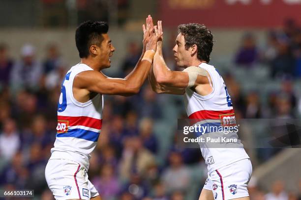 Lin Jong and Robert Murphy of the Bulldogs celebrate a goal during the round three AFL match between the Fremantle Dockers and the Western Bulldogs...