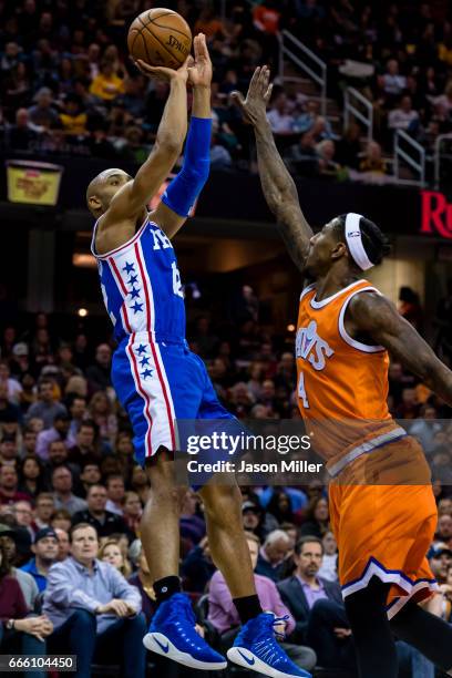 Gerald Henderson of the Philadelphia 76ers shoots over Iman Shumpert of the Cleveland Cavaliers during the first half at Quicken Loans Arena on March...