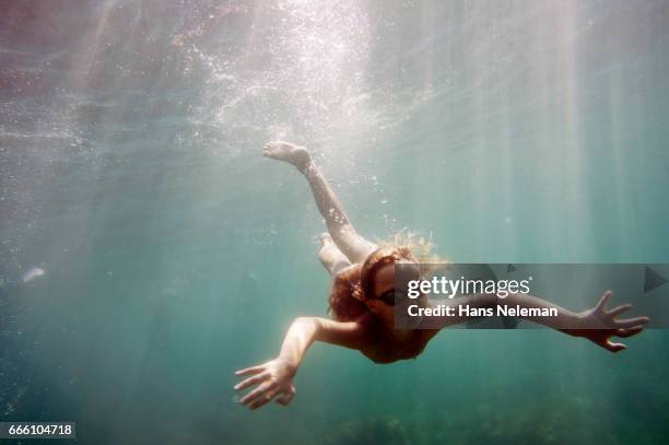 underwater view of girl diving - girl looking down stock pictures, royalty-free photos & images