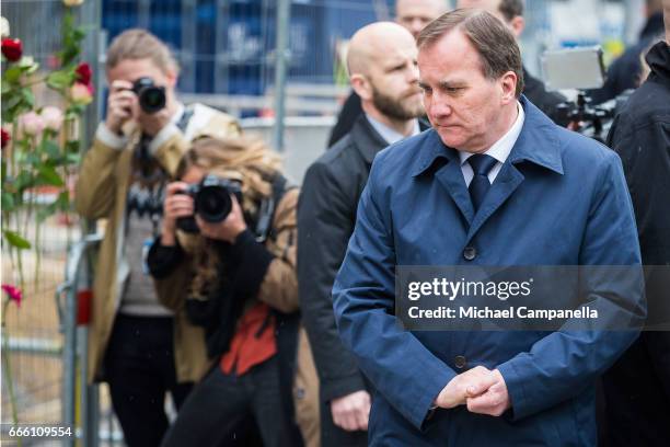 Sweden's Prime Minister Stefan Lofven visits the scene of a terrorist attack where a truck crashed after driving down a pedestrian street in downtown...