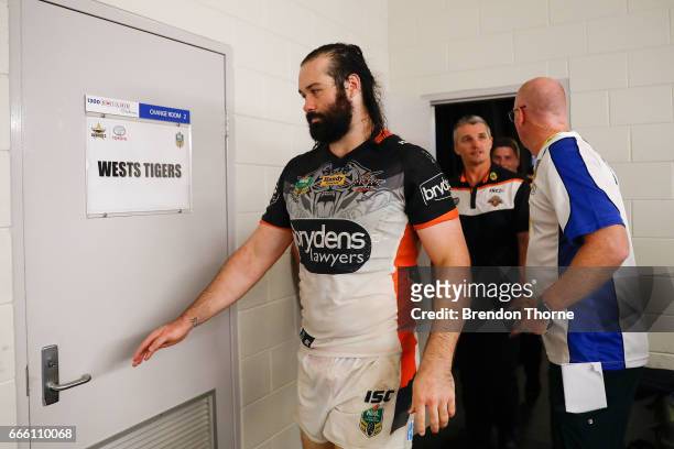 Aaron Woods of the Tigers and Ivan Cleary walk to the dressing room following a press conference during the round six NRL match between the North...