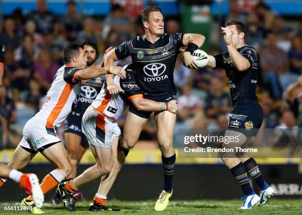 Coen Hess of the Cowboys offloads to a team mate during the round six NRL match between the North Queensland Cowboys and the Wests Tigers at...