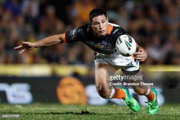 Mitchell Moses of the Tigers gathers a loose ball during the round six NRL match between the North Queensland Cowboys and the Wests Tigers at...
