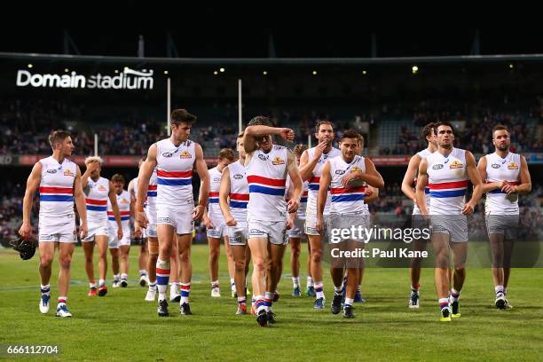 Robert Murphy of the Bulldogs leads his team from the field after being defeated during the round three AFL match between the Fremantle Dockers and...