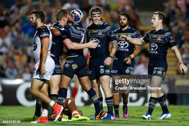 Coen Hess of the Cowboys celebrates with team mates after scoring a try during the round six NRL match between the North Queensland Cowboys and the...