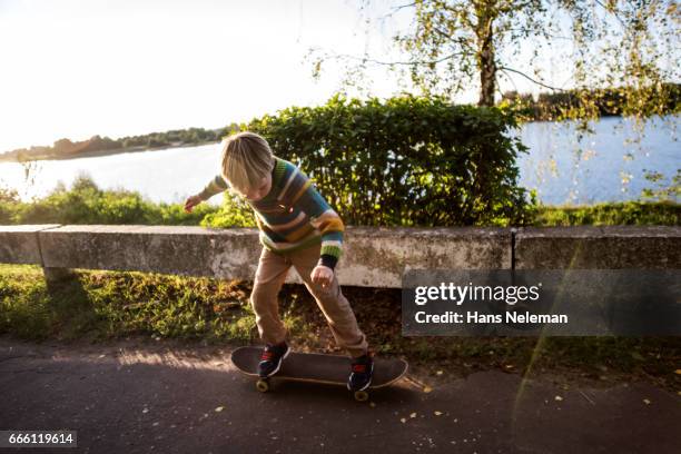 boy with skateboard - skate sports footwear stock-fotos und bilder
