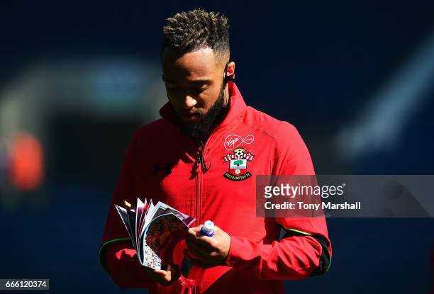 Nathan Redmond of Southampton reads the match day programme on the pitch prior to the Premier League match between West Bromwich Albion and...