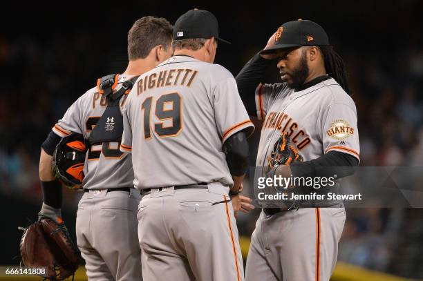Dave Righetti of the San Francisco Giants talks with Johnny Cueto in the fourth inning against the Arizona Diamondbacks at Chase Field on April 4,...