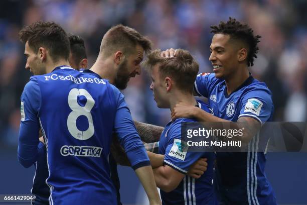 Guido Burgstaller of Schalke celebrates with his team-mates after scoring a goal to make it 1-0 during the Bundesliga match between FC Schalke 04 and...