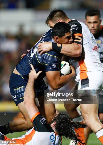 Jason Taumalolo of the Cowboys is tackled by the Tigers defence during the round six NRL match between the North Queensland Cowboys and the Wests...