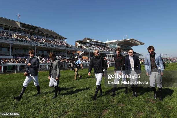 Ruby Walsh walks down the course with fellow jockeys during day three of the Randox Health Grand National meeting at Aintree Racecourse on April 8,...