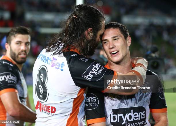 Aaron Woods and Mitchell Moses of the Tigers celebrate at full time during the round six NRL match between the North Queensland Cowboys and the Wests...