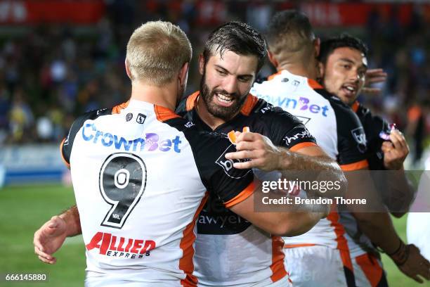 James Tedesco and Matt McIlwrick of the Tigers celebrate at full time during the round six NRL match between the North Queensland Cowboys and the...