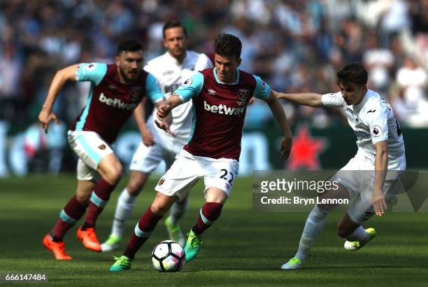 Sam Byram of West Ham United attempts to take the ball past Tom Carroll of Swansea City during the Premier League match between West Ham United and...