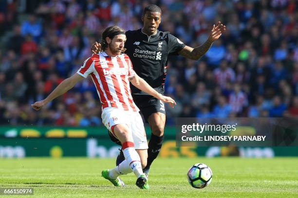 Stoke City's Welsh midfielder Joe Allen vies with Liverpool's Dutch midfielder Georginio Wijnaldum during the English Premier League football match...