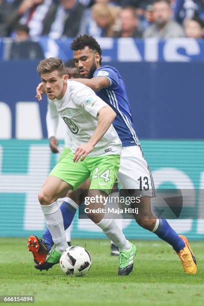 Eric Maxim Choupo-Moting of Schalke and Sebastian Jung of Wolfsburg battle for the ball during the Bundesliga match between FC Schalke 04 and VfL...