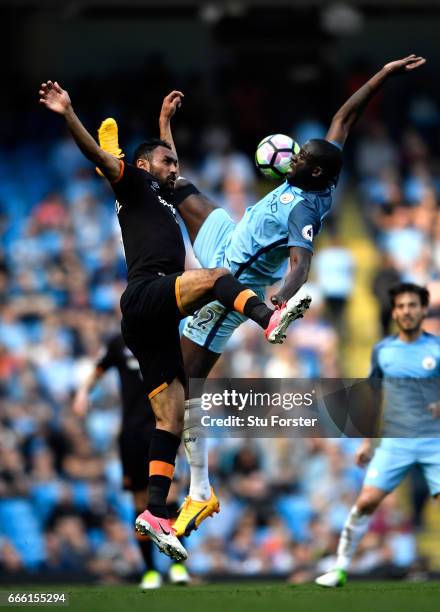 Ahmed Elmohamady of Hull City and Yaya Toure of Manchester City battle for possession during the Premier League match between Manchester City and...