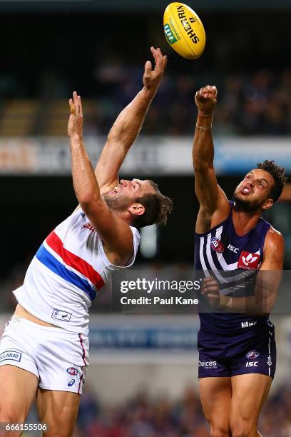 Michael Johnson of the Dockers spoils the mark for Travis Cloke of the Bulldogs during the round three AFL match between the Fremantle Dockers and...