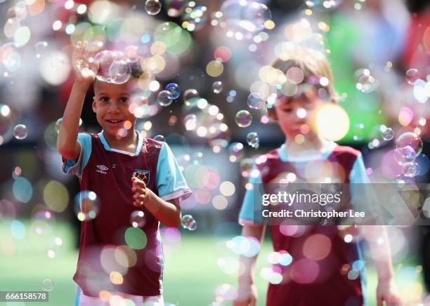 The West Ham United mascots paly with the bubbles prior to the Premier League match between West Ham United and Swansea City at London Stadium on...