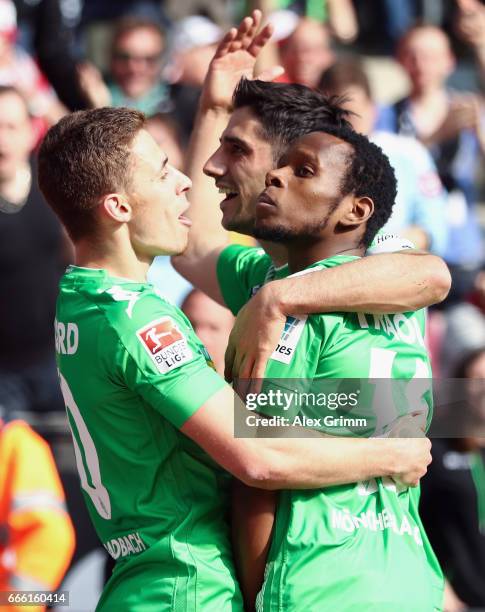 Ibrahima Traore of Moenchengladbach celebrates his team's second goal with team mates Thorgan Hazard and Lars Stindl during the Bundesliga match...