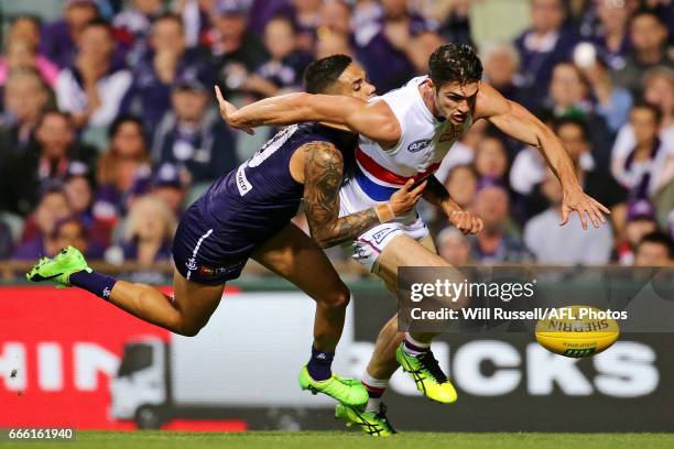 Michael Walters of the Dockers tries to tackle Easton Wood of the Bulldogs during the round three AFL match between the Fremantle Dockers and the...