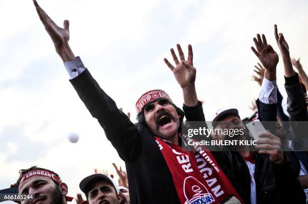Man wearing a scarf reading the name of Turkish President gestures as he shouts during a campaign rally for the "yes" in Istanbul, on April 8, 2017...