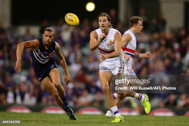 Marcus Bontempelli of the Bulldogs handballs during the round three AFL match between the Fremantle Dockers and the Western Bulldogs at Domain...
