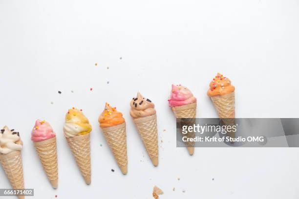 colorful ice cream candy in a row - ice cream cone stock-fotos und bilder