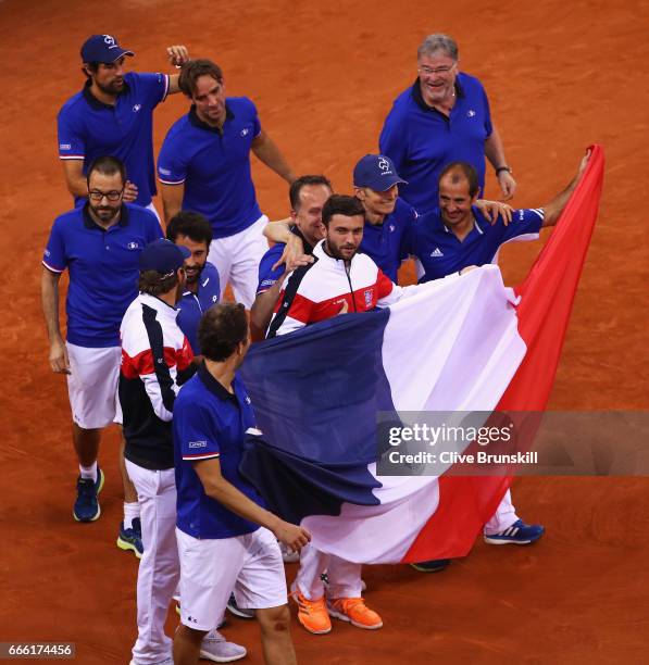 The France team celebrate victory after the doubles match between Dominic Inglot and Jamie Murray of Great Britain and Julien Benneteau and Nicolas...