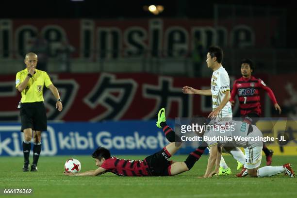 Yuta Toyokawa of Fagiano Okayama is fouled by Tomonobu Hiroi of Zweigen Kanazawa during the J.League J2 match between Fagiano Okayama and Zweigen...