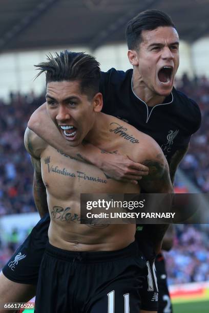 Liverpool's Brazilian midfielder Roberto Firmino celebrates scoring his team's second goal with Liverpool's Brazilian midfielder Philippe Coutinho...