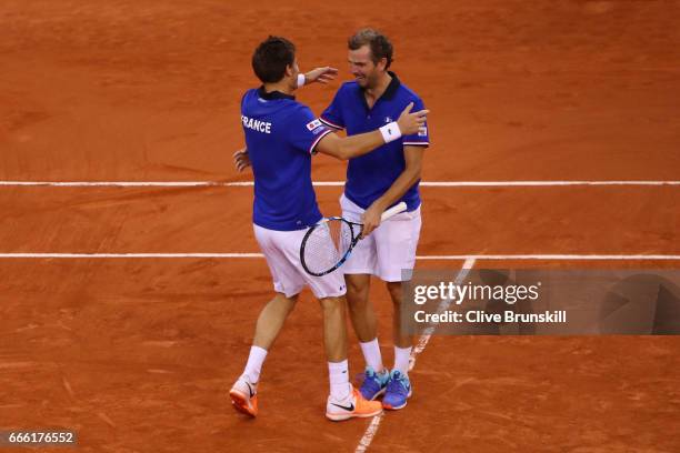 Julien Benneteau and Nicolas Mahut of France celebrate victory in their doubles match against Jamie Murray and Dominic Inglot of Great Britain during...