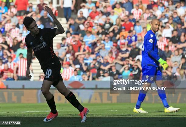 Liverpool's Brazilian midfielder Philippe Coutinho celebrates scoring his team's first goal during the English Premier League football match between...