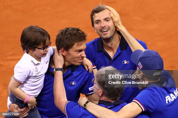 Julien Benneteau and Nicolas Mahut of France celebrate victory in their doubles match against Jamie Murray and Dominic Inglot of Great Britain during...