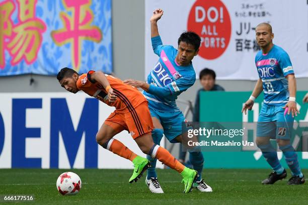 Rony of Albirex Niigata and Hiroyuki Taniguchi of Sagan Tosu compete for the ball during the J.League J1 match between Sagan Tosu and Albirex Niigata...