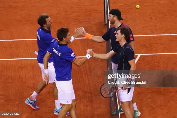 Julien Benneteau and Nicolas Mahut of France celebrate victory in their doubles match against Jamie Murray and Dominic Inglot of Great Britain during...