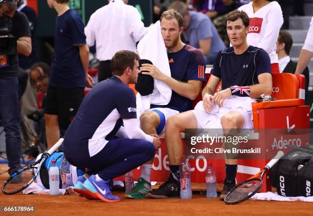 Jamie Murray and Dominic Inglot of Great Britain look dejected with captain Leon Smith after their doubles defeat to Julien Benneteau and Nicolas...