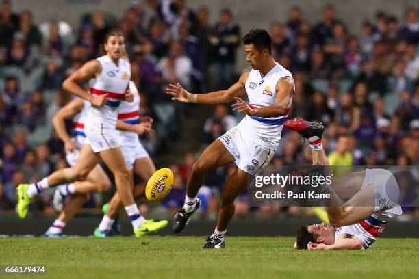 Lin Jong of the Bulldogs passes the ball during the round three AFL match between the Fremantle Dockers and the Western Bulldogs at Domain Stadium on...