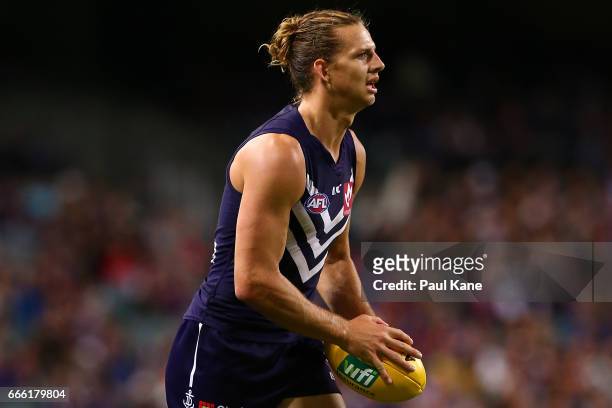 Nathan Fyfe of the Dockers looks to pass the ball during the round three AFL match between the Fremantle Dockers and the Western Bulldogs at Domain...