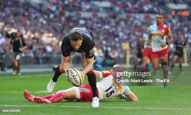 Chris Ashton of Saracens beats Mike Brown of Harlequins to score a try during the Aviva Premiership match between Saracens and Harlequins at Wembley...
