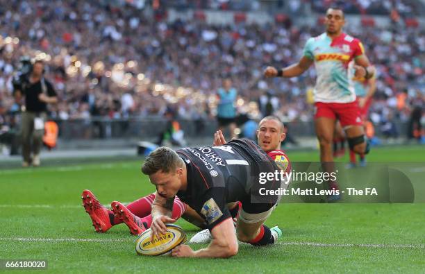 Chris Ashton of Saracens beats Mike Brown of Harlequins to score a try during the Aviva Premiership match between Saracens and Harlequins at Wembley...