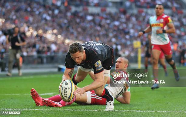 Chris Ashton of Saracens beats Mike Brown of Harlequins to score a try during the Aviva Premiership match between Saracens and Harlequins at Wembley...